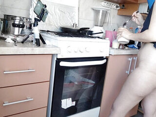 Sexy Latina bare in the kitchen. Uber-sexy naked wifey prepares food in the kitchen.