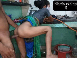 Sister-in-law was cutting papaya in the kitchen and the brother from behind.