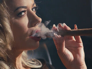Horny cougar with fat fun bags stroking and providing blow-job While Smoking a 9 Inch Cigar