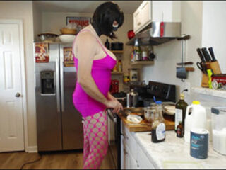 Giant fake titties crossdresser in rosy dress making breakfast